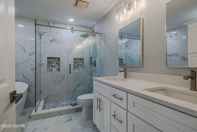 bathroom featuring toilet, a textured ceiling, a shower with shower door, and vanity