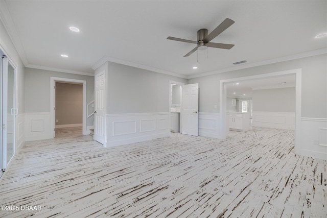 interior space with light wood-type flooring, ceiling fan, and ornamental molding