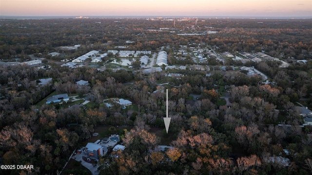 aerial view at dusk featuring a water view