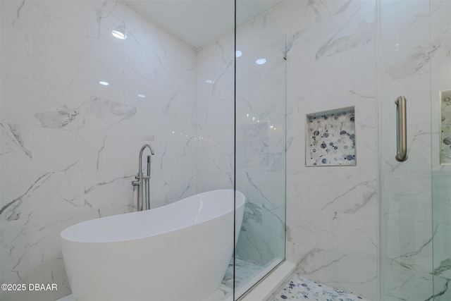 bathroom featuring tile walls and shower with separate bathtub