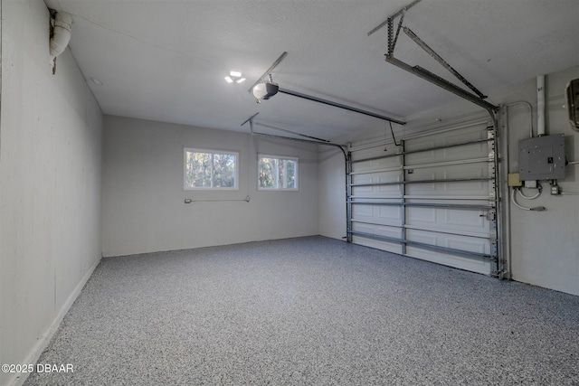 garage featuring electric panel and a garage door opener