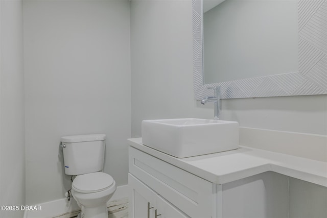 bathroom featuring toilet and vanity