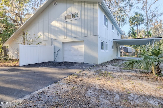 view of side of property with a carport and a garage