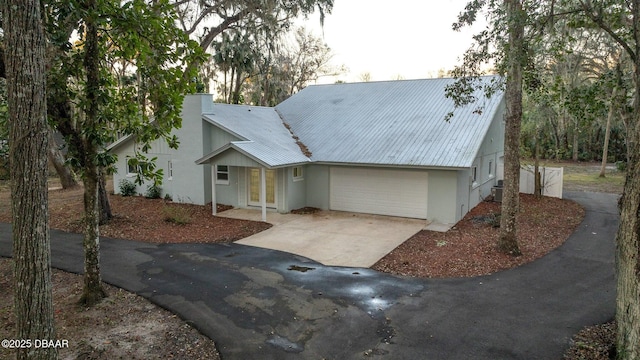 view of front of property with cooling unit and a garage