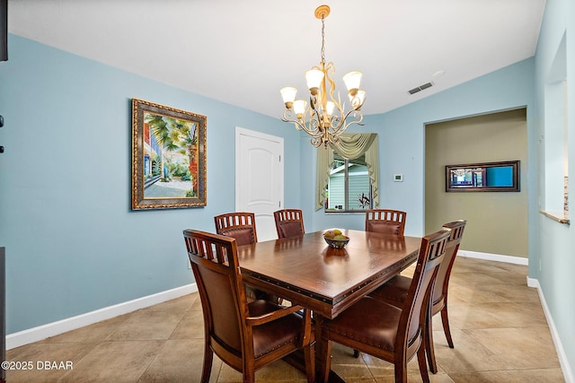 dining area with lofted ceiling, light tile patterned floors, and an inviting chandelier