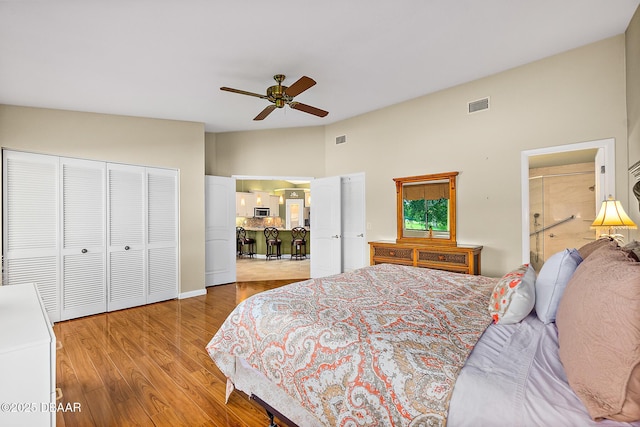 bedroom with vaulted ceiling, hardwood / wood-style floors, and ceiling fan