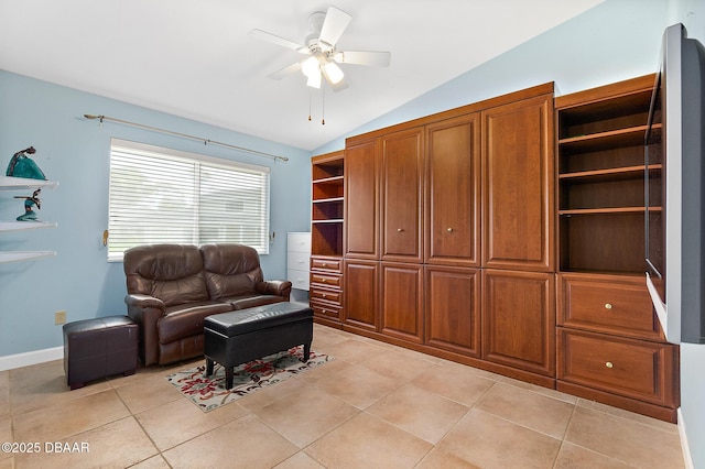 living room featuring light tile patterned floors, vaulted ceiling, and ceiling fan