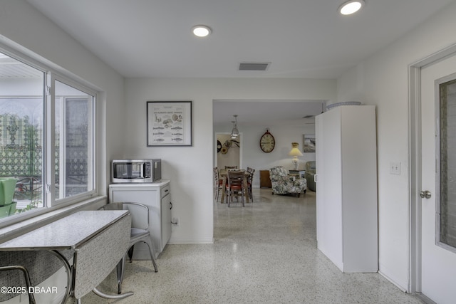 9 San Jose Cir, Ormond Beach, FL 32176 - corridor featuring dark speckled floor, recessed lighting, and baseboards