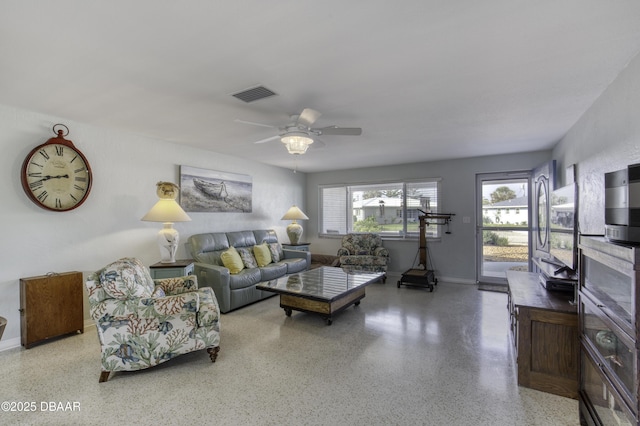 9 San Jose Cir, Ormond Beach, FL 32176 - living room with speckled floor, a ceiling fan, and baseboards