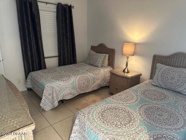 bedroom with light tile patterned floors