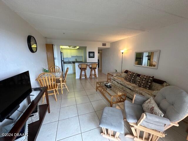 2700 Ocean Shore Blvd Unit 108, Ormond Beach, FL 32176 - living room with light tile patterned floors