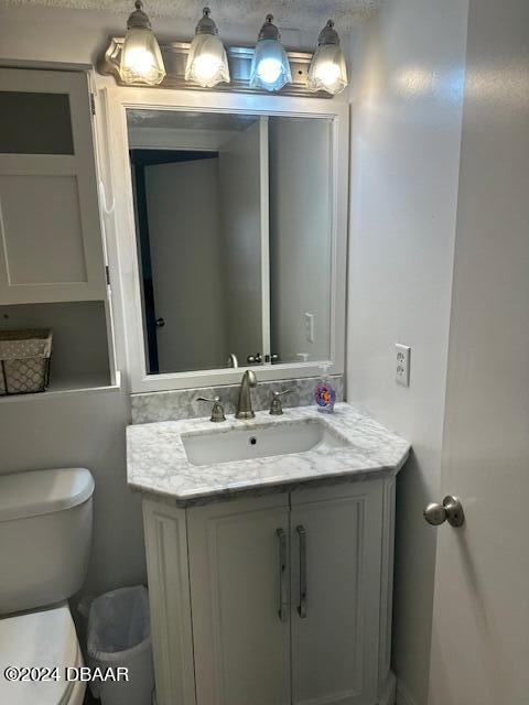 2700 Ocean Shore Blvd Unit 108, Ormond Beach, FL 32176 - half bathroom featuring toilet and vanity