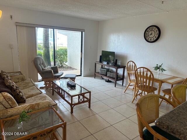 2700 Ocean Shore Blvd Unit 108, Ormond Beach, FL 32176 - living area with light tile patterned floors and a textured ceiling