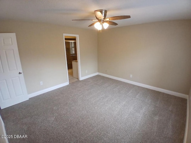spare room with carpet, baseboards, and a ceiling fan