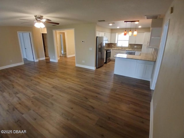 kitchen with a peninsula, stainless steel appliances, visible vents, white cabinetry, and open floor plan