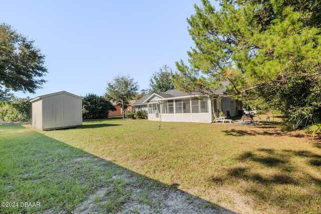 74 Fulton Pl, Palm Coast, FL 32137 - view of grassy yard with a sunroom