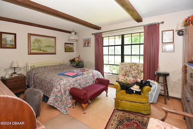 carpeted bedroom featuring beam ceiling