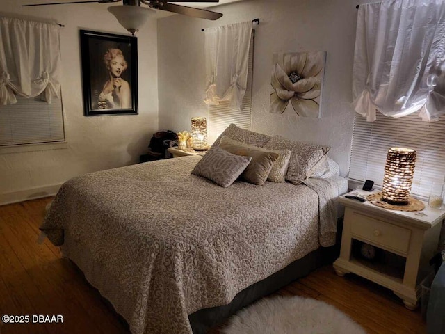 bedroom with a ceiling fan and wood finished floors