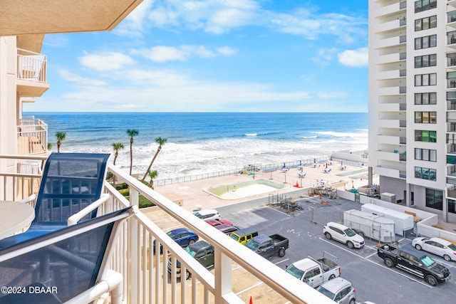 balcony featuring a water view and a view of the beach