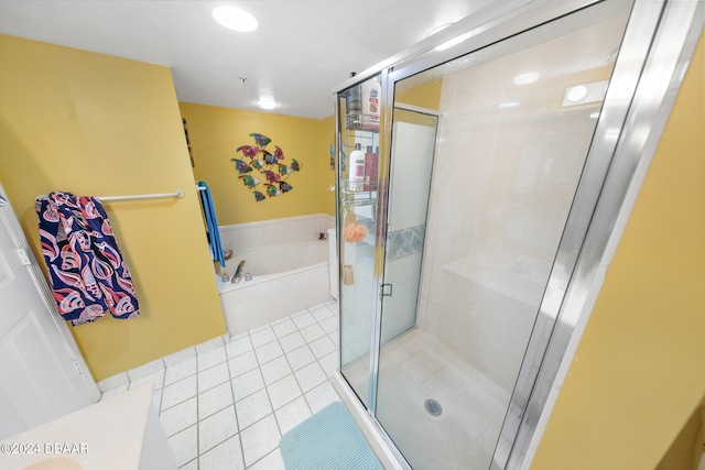 bathroom with separate shower and tub and tile patterned floors