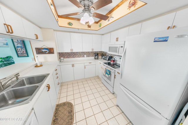 kitchen with white cabinets, sink, and white appliances