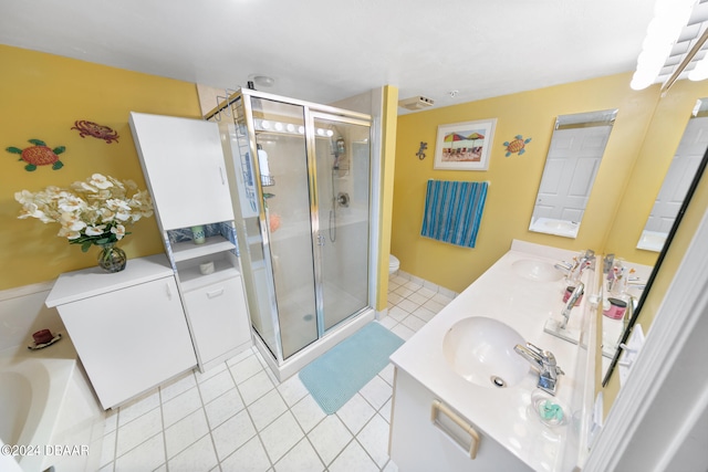 bathroom with toilet, vanity, tile patterned floors, and a shower with shower door