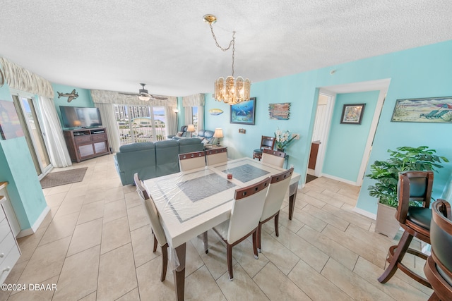 dining area with a textured ceiling, light tile patterned flooring, and ceiling fan with notable chandelier