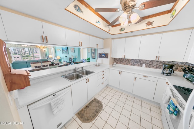 kitchen featuring white appliances, sink, white cabinets, kitchen peninsula, and ceiling fan