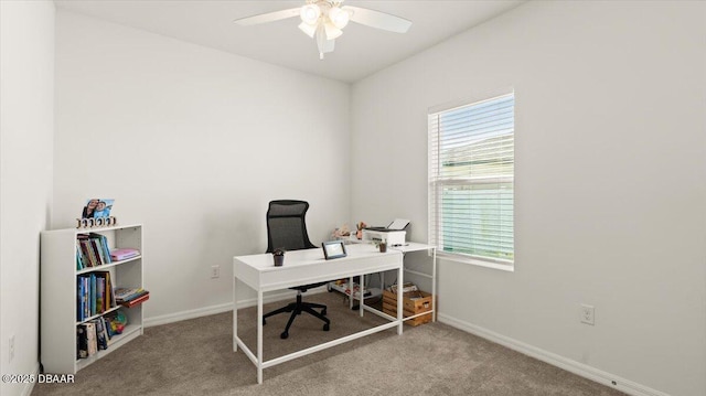 carpeted office with a healthy amount of sunlight, baseboards, and ceiling fan