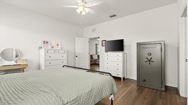 bedroom featuring dark wood finished floors, baseboards, visible vents, and a ceiling fan