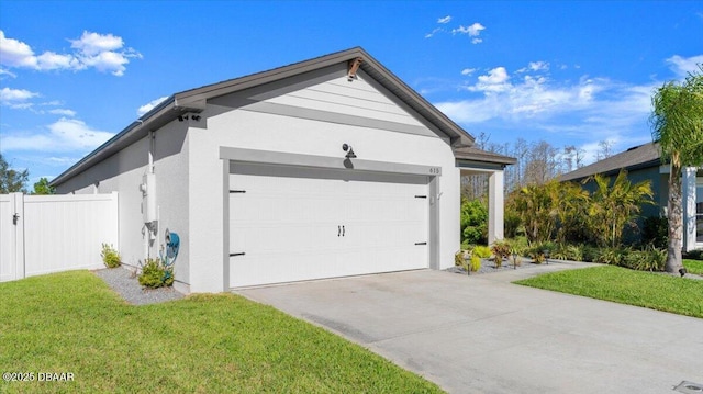 view of side of home featuring fence, a yard, stucco siding, concrete driveway, and a garage