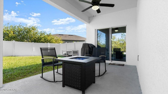 view of patio with a ceiling fan, a fire pit, and fence