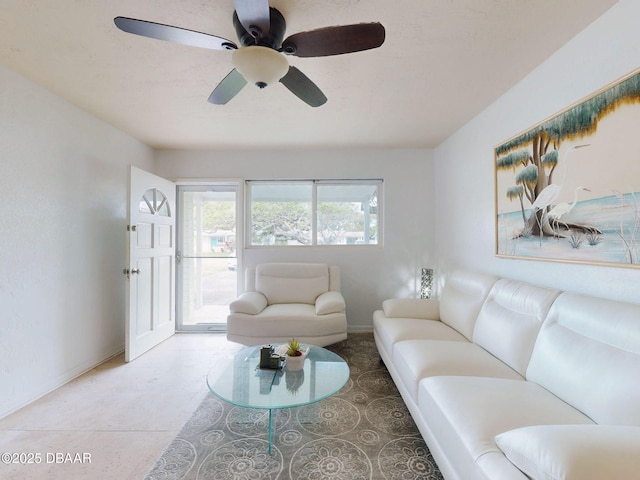 823 E 10th Ave, New Smyrna Beach, FL 32169 - living room featuring a ceiling fan and baseboards