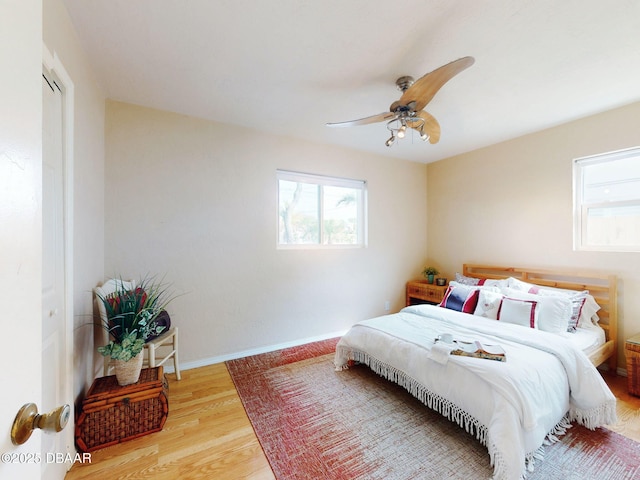 823 E 10th Ave, New Smyrna Beach, FL 32169 - bedroom featuring multiple windows, wood finished floors, and a ceiling fan