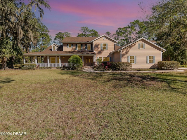 view of front of home featuring a porch and a yard