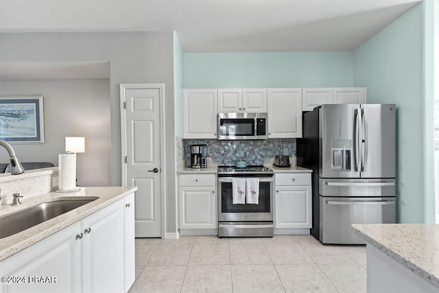 kitchen with white cabinetry, sink, decorative backsplash, and appliances with stainless steel finishes