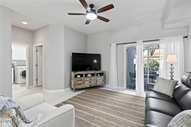 living room featuring washer / clothes dryer and ceiling fan