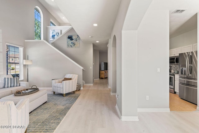 interior space with light wood-type flooring and a healthy amount of sunlight