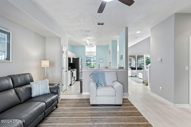 living room featuring light wood-type flooring and ceiling fan