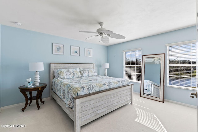 bedroom with multiple windows, light carpet, and ceiling fan