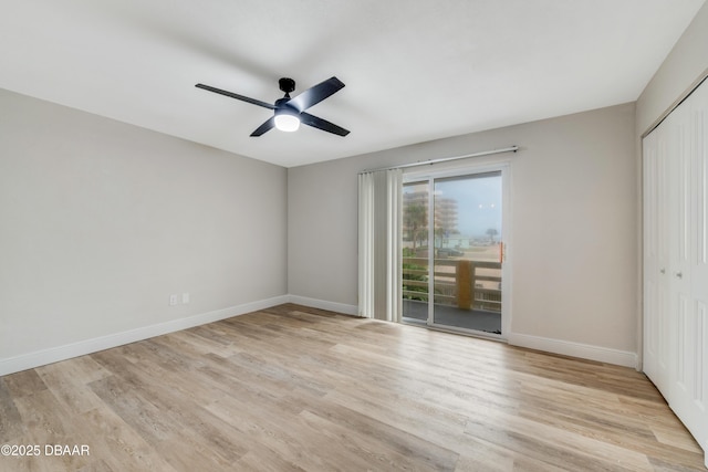 empty room with ceiling fan and light hardwood / wood-style floors