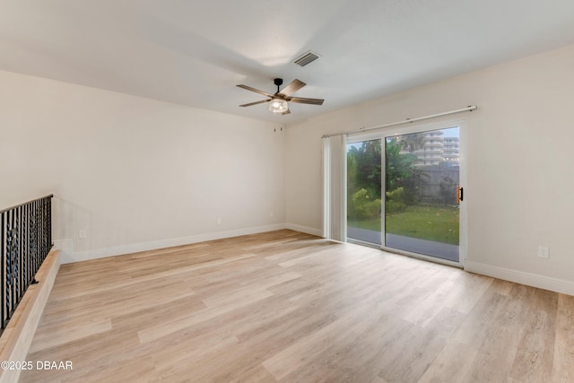 unfurnished room with ceiling fan and light wood-type flooring