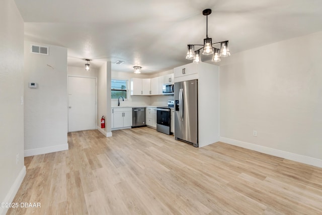 kitchen with light hardwood / wood-style flooring, decorative light fixtures, stainless steel appliances, white cabinets, and sink