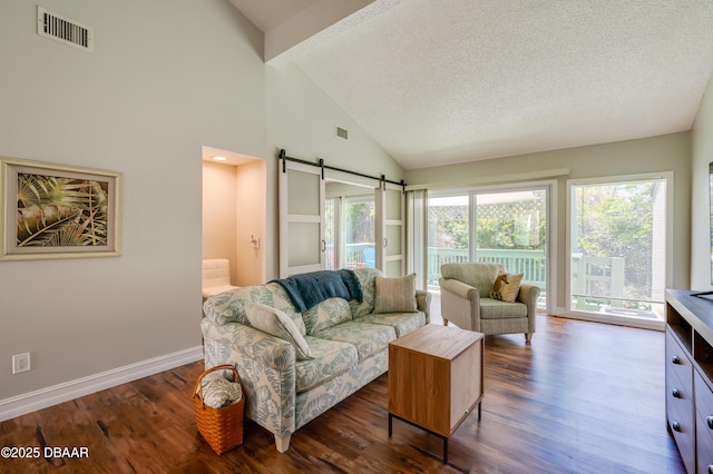 113 Club House Blvd, New Smyrna Beach, FL 32168 - living room featuring a barn door, visible vents, and dark wood finished floors