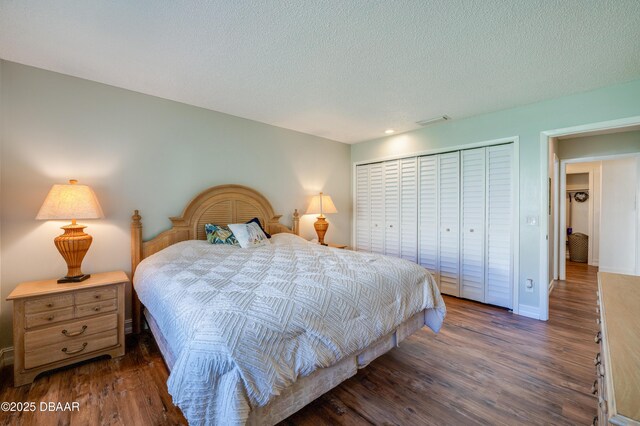 113 Club House Blvd, New Smyrna Beach, FL 32168 - bedroom featuring a closet, a textured ceiling, dark wood finished floors, baseboards, and visible vents