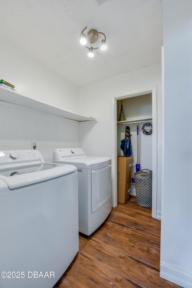 113 Club House Blvd, New Smyrna Beach, FL 32168 - laundry area featuring washer and clothes dryer, a textured ceiling, laundry area, and wood finished floors