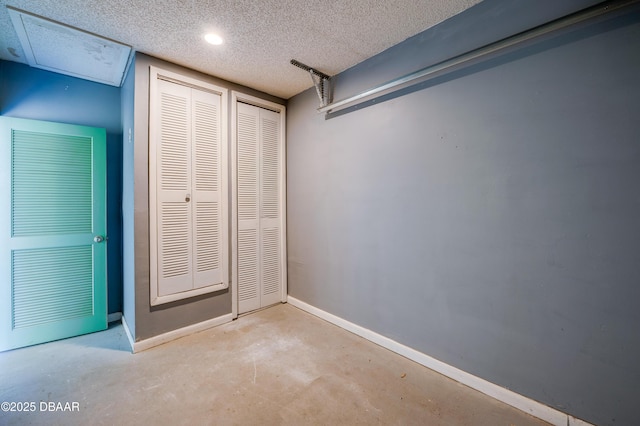 113 Club House Blvd, New Smyrna Beach, FL 32168 - unfurnished bedroom with baseboards, concrete floors, and a textured ceiling
