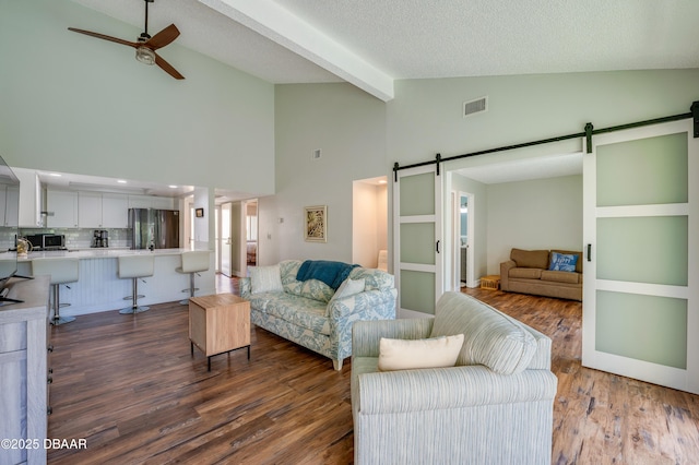 113 Club House Blvd, New Smyrna Beach, FL 32168 - living room with visible vents, ceiling fan, wood finished floors, beam ceiling, and a barn door