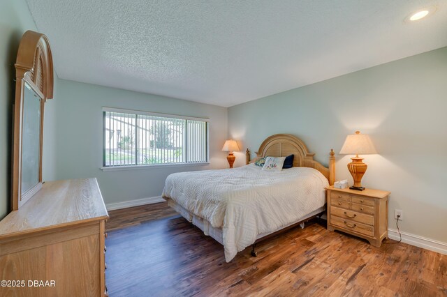 113 Club House Blvd, New Smyrna Beach, FL 32168 - bedroom featuring baseboards, a textured ceiling, and wood finished floors