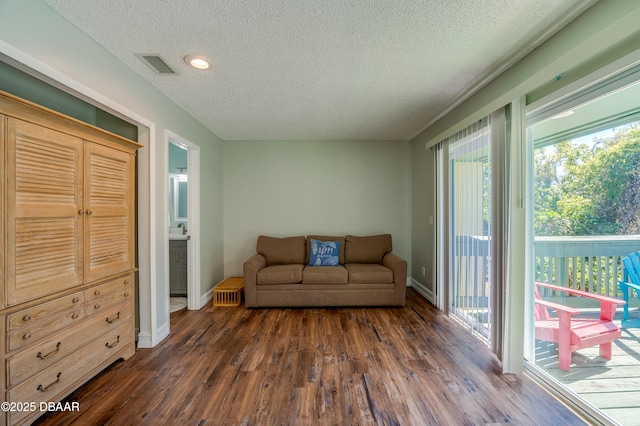113 Club House Blvd, New Smyrna Beach, FL 32168 - living area with baseboards, dark wood-style flooring, and visible vents